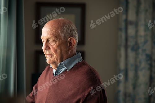 Preview: Upset senior man near window