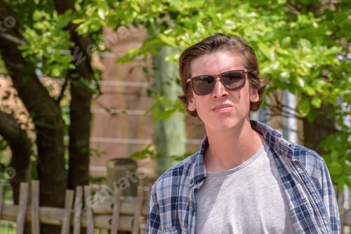 Preview: College student wearing sunglasses in summer