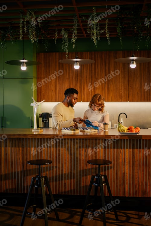 Preview: Interracial staff in eco friendly workspace working on sustainable project