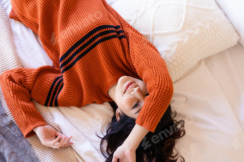 Preview: Portraits of Asian women wearing Sweaters. She rested on the bed.