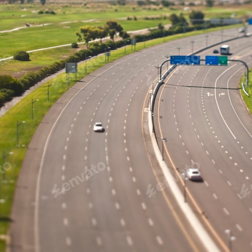 Preview: Highway with cars and golf course.