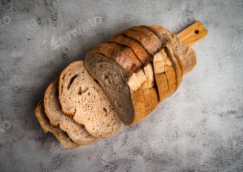 Preview: Sourdough bread loaf with sliced pieces on cutting board