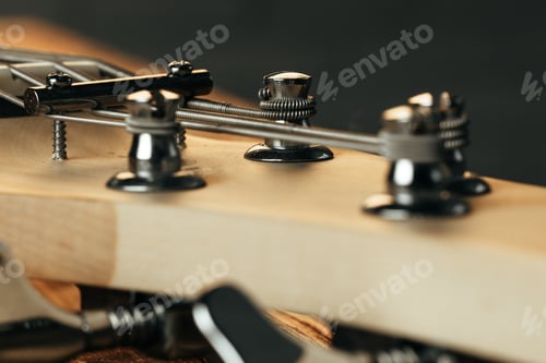 Preview: Guitar headstock with tuners on dark background