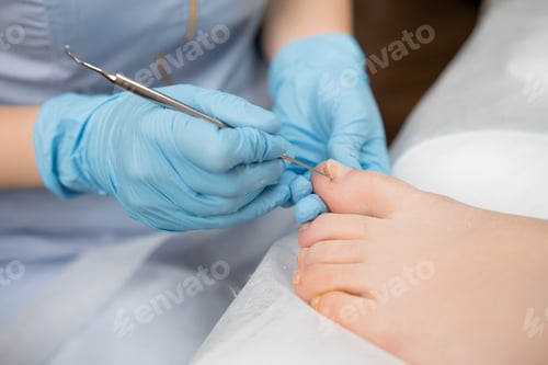 Preview: Woman feet receiving pedicure in beauty clinic