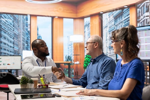 Preview: Financial broker shaking hands in agreement with senior man