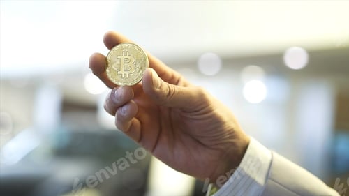 Preview: Businessman hand holding glowing bitcoin sign. Stock. Virtual money concept and Financial growth