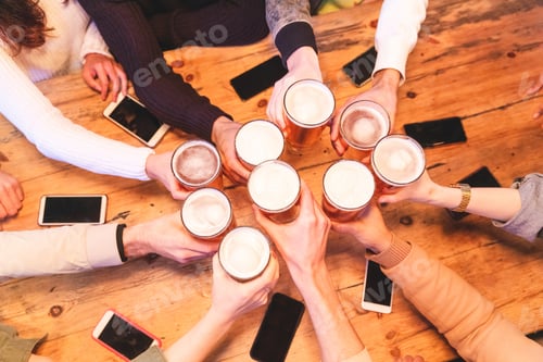 Preview: Friends drinking and toasting beer at pub