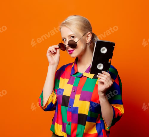 Preview: Style blonde in 90s clothes with VHS cassette