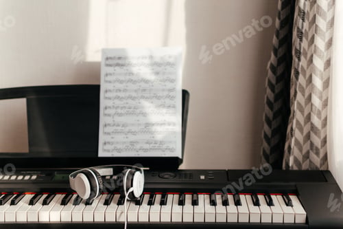 Preview: Headphones on musical synthesizer keyboard. Headphones on electronic piano