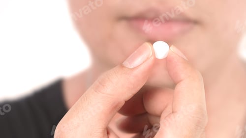 Preview: People taking or holding a white medicine pill in hand