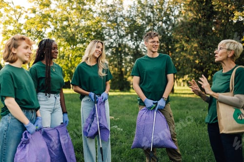 Preview: Group of volunteers collecting garbage in park