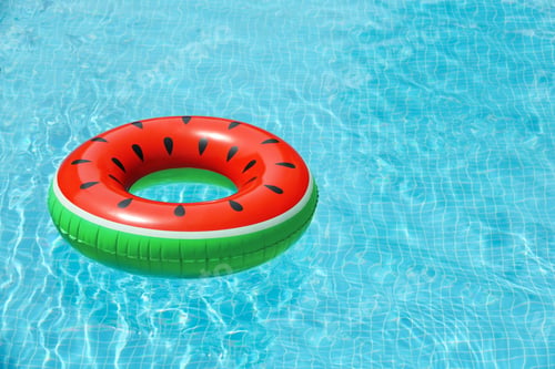 Preview: Inflatable ring floating in pool on sunny day