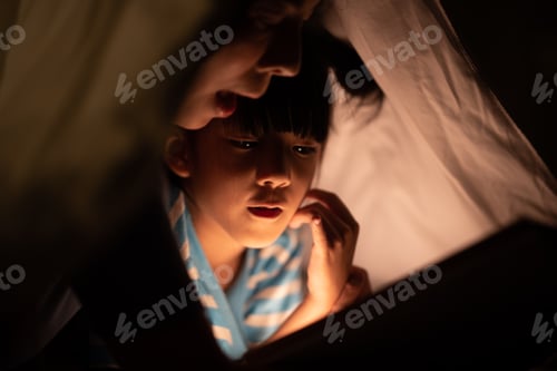 Preview: young Asian mother with little child daughter family happy in cozy night light at childhood home