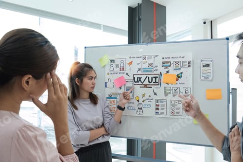 Preview: group of asian ux developer and ui designer serious brainstorming about mobile app interface on