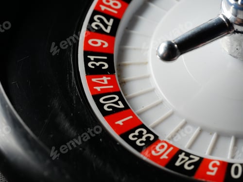 Preview: Closeup of a roulette wheel miniature on dark background