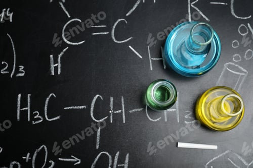 Preview: Laboratory glassware on blackboard with chemical formulas, flat lay