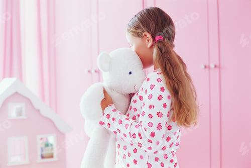 Preview: Girl hugging her teddy bear