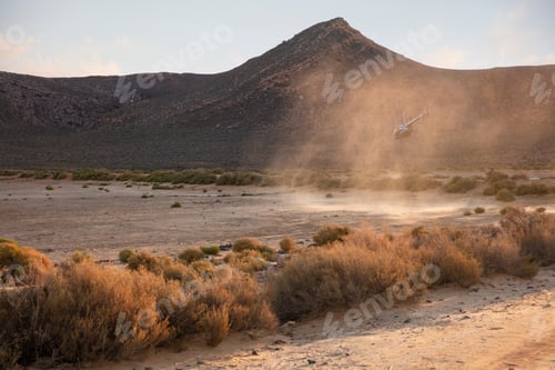 Preview: Helicopter causing dust storm during desert landing.