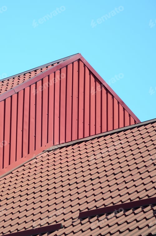 Preview: A fragment of a roof from a metal tile of dark red color. Quality Roofing