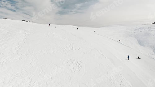 Preview: Livigno, Italy - February 21, 2022: People snowboarding skiing at ski resort. Skiers, snowboarders