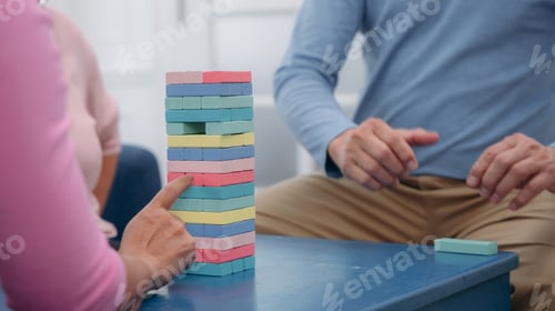 Preview: Senior playing a wood block on the tower. People pulling wood block on the tower.