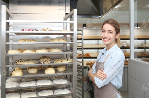 Preview: Baker at rack with pastries in workshop