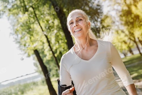 Preview: Close up of mature woman running in park