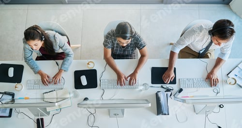 Preview: High angle shot of a team of call center agents working in an office