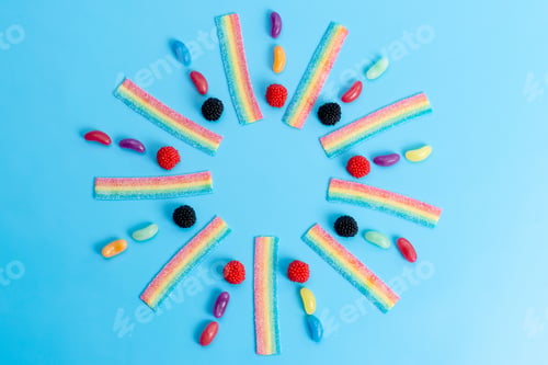 Preview: a top view marmalades and candies colorful on the blue desk candy sweet sugar