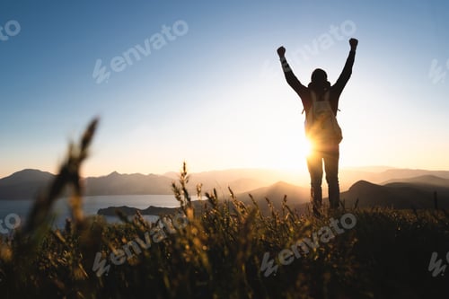 Preview: Man praying at sunset mountains raised hands