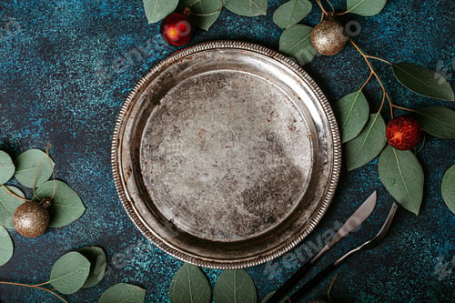 Preview: Empty metal plate top view on Christmas table