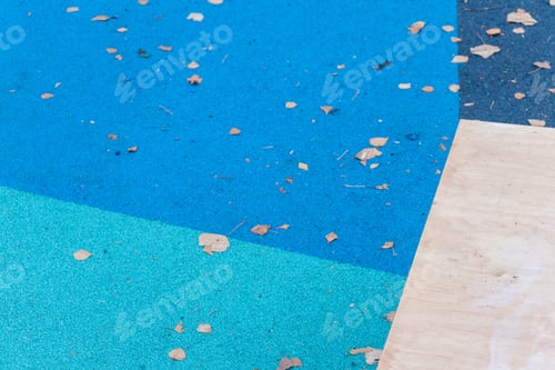 Preview: Abstract Geometry: Blue Rubber Sports Playground with Fallen Leaves, Iron Monkey Bars, Urban Element