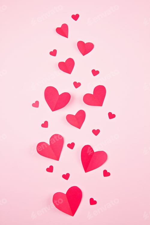 Preview: Paper hearts over the pink pastel background. Abstract background with paper cut shapes