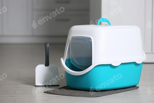 Preview: Cat litter box and scoop on floor in room