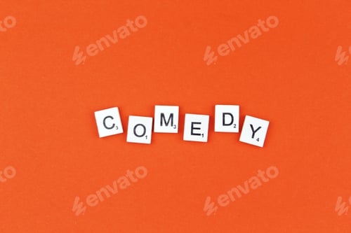 Preview: Comedy scrabble letters word on a orange background. Film genre
