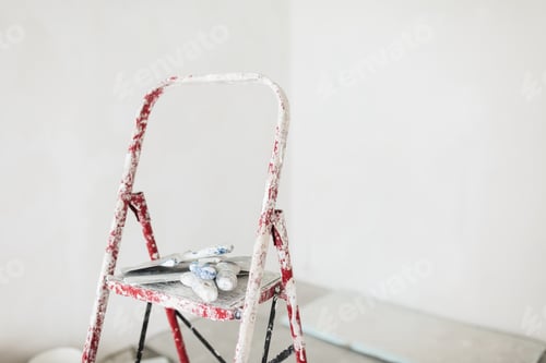 Preview: Close up ladder with putty knives over white background isolated