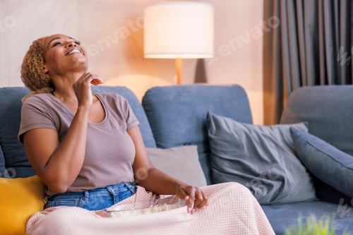 Preview: Woman having fun watching TV at home
