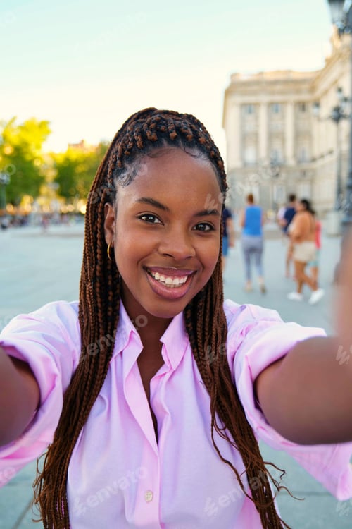 Preview: Black young woman doing a selfie in Madrid, Spain.