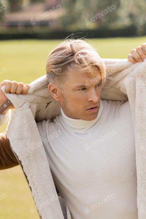 Preview: Blonde man in park