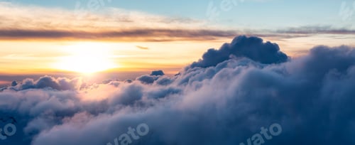 Preview: Cloudscape over the Canadian Mountains. Aerial Clouds Background Panorama Sunset