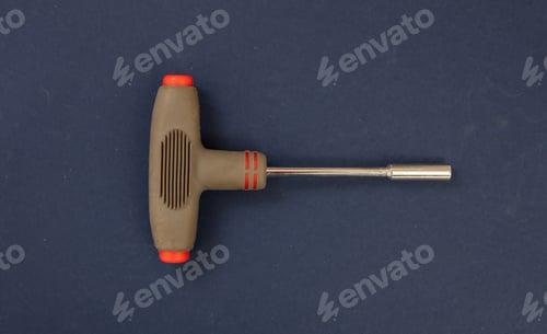 Preview: Allen wrench with brown color rubber handle on blue background. Overhead, close up view.