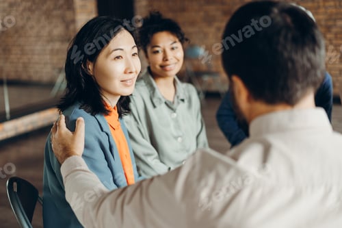 Preview: Psychotherapist comforting patient during group therapy session