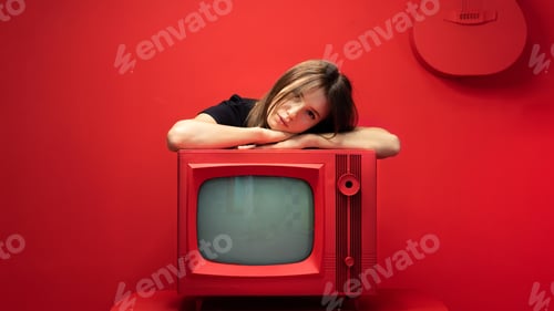 Preview: Young woman posing in a studio with red walls and furniture