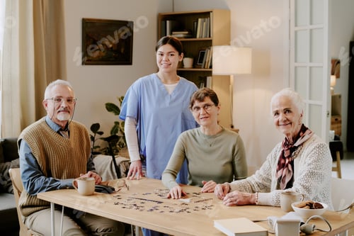 Preview: Group of Senior People Solving Puzzle with Young Hispanic Woman
