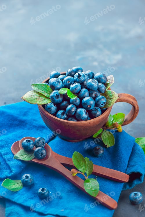 Preview: Bowl of Fresh Blueberries with Leaves and Spoons