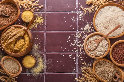 Preview: White, brown and red rice, buckwheat, millet, corn groats, quinoa and bulgur in wooden bowls on a br