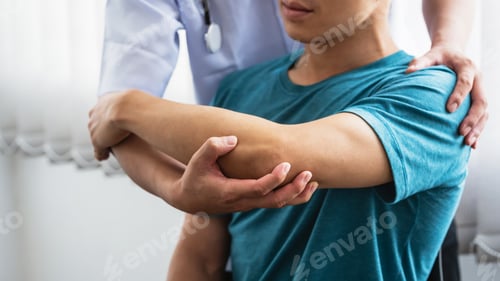Preview: Man physiotherapist stretching shoulder and arm patient at a clinic.