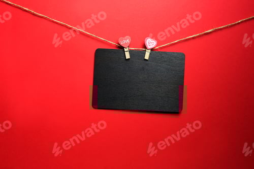Preview: Hanging Blackboard with Heart Clothespins on Red Background