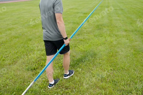 Preview: Wearing Sportswear While Holding a Javelin on Grass Field
