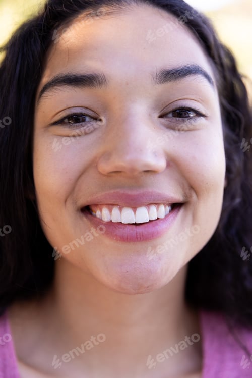 Preview: Close up portrait of happy biracial woman in sunny nature